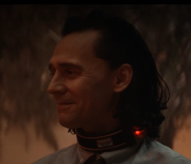 Loki has a big smile that reaches his eyes as he looks at Mobius (the screenshot is just Loki's face).